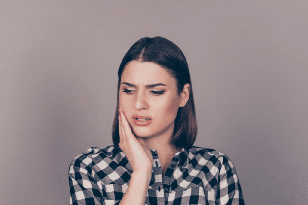 Woman experiencing jaw discomfort related to bite problems in Glasgow, KY